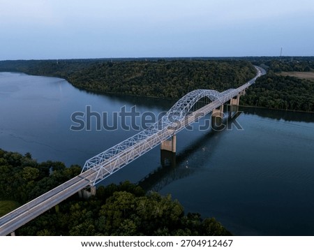 This is a sunset view of the Carroll Lee Cropper Bridge, a steel arch and Warren through truss, carries Interstate 275 over the Ohio River between Petersburg, Kentucky, and Lawrenceburg, Indiana.