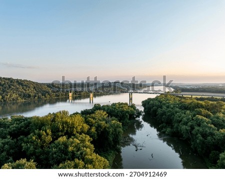 This is a sunset view of the Carroll Lee Cropper Bridge, a steel arch and Warren through truss, carries Interstate 275 over the Ohio River between Petersburg, Kentucky, and Lawrenceburg, Indiana.