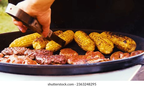 In this tantalizing image, the stage is set for a carnivore's dream and a corn lover's delight, as the smoky aroma of a grill wafts through the air. - Shutterstock ID 2363248295