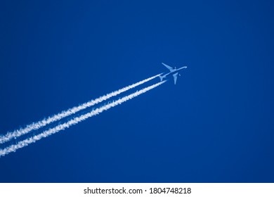 This is a telephoto close up image of jet aircraft with vapor trails contrails flying from Tokyo to Detroit cruising at 41,000 feet with at a ground speed of 535 knots