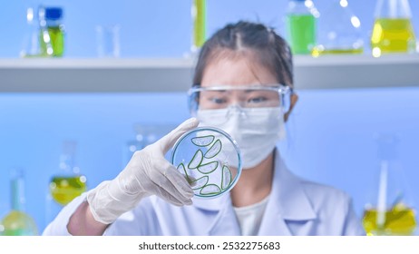 In this template image, experts are shown closely examining aloe vera plants in clear glass pots while handling them tenderly in a contemporary laboratory atmosphere. - Powered by Shutterstock