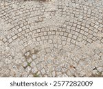 This textured cobblestone surface features a circular pattern, providing an ideal backdrop for creative projects and text placement.