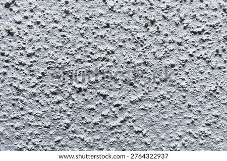 This textured surface displays a grainy look suitable for background design. It offers a unique and simple backdrop that can be used in various concepts and projects.