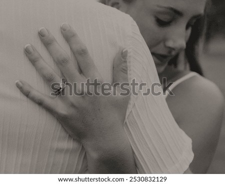 This timeless image captures the deep connection of a bride and groom on their wedding day. It emphasizes the commitment of the engagement ring, and a soft smile on the bride's face.