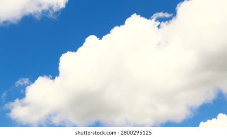 This tranquil skyscape features a boundless blue sky dotted with fluffy white cumulus clouds on a bright, clear day, evoking a strong sense of peace, hope, and freedom. It embodies purity and the promise of a fresh start, perfect for themes of clean air and environmental well-being. Ideal for nature conservation, travel promotions, and environmental campaigns seeking an optimistic, serene background that promotes sustainability and healthy living