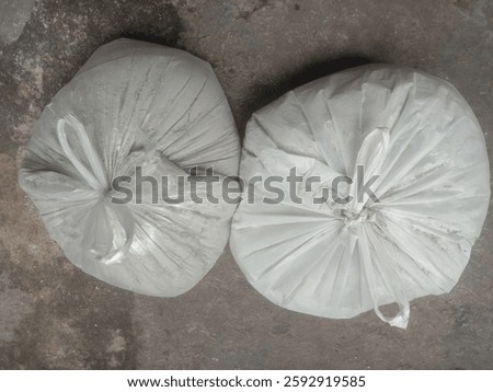 This type of packaging is commonly used for construction materials, waste disposal, or storage of bulk items. The scene suggests an industrial, construction,