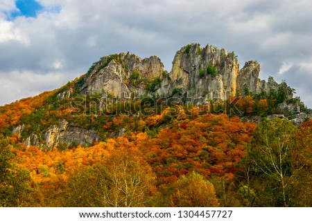 This is the upper area of Seneca Rocks National Recreational Area in the Monongahela National Forest in West Virginia. Beautiful orange Autumn colors surround the rocks of this famous climbing area.