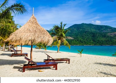 This is the vacation time show wood chairs on a beautiful tropical beach with white sand and clear turquoise ocean at exotic island