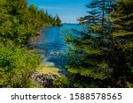 This is a view from an inlet of the main island of Isle Royale National Park in Lake Superior off Copper Harbor, Michigan. Tiny islands are in the distance.