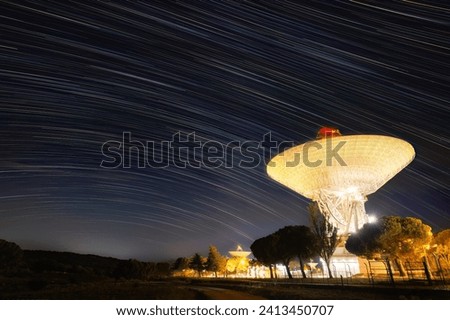 This is a view of the main antenna in the Madrid Deep Space Communications Complex (MDSCC) NASA with  the star trail