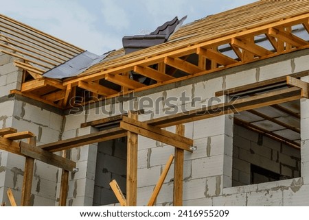 This is view of new incomplete modern house without tiles on roof. It is unfinished building apartment
