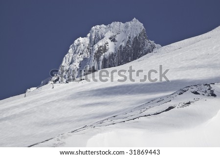 This is a view from a rest stop of highway 26.You can see a couple of people skiing down the mountain.