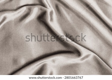 This visual features a soft texture with smooth fabric creating an appealing background. The folds suggest an inviting space suitable for text or other design elements.