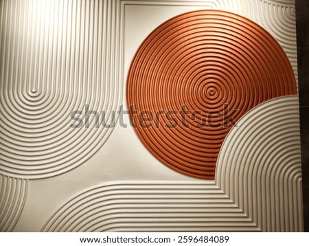 This wall design features white and orange geometric shapes, with circular textures creating a modern backdrop for text.