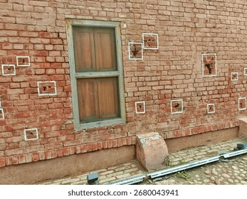 This is a wall inside Jallianwala Bagh, Amritsar.
The bullet marks from the 1919 massacre are still preserved and highlighted with white squares, serving as a memorial to the tragic event.

