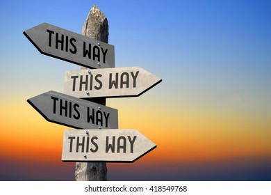 This way concept - wooden signpost and sunset sky. - Shutterstock ID 418549768