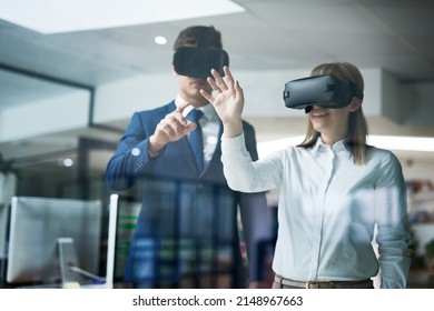 This is what the future of business looks like. Multiple exposure shot of two coworkers brainstorming together in the office while wearing VR headsets. - Powered by Shutterstock