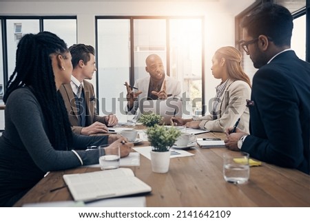 This is what Ive envisioned. Shot of a group of young businesspeople having a meeting in a modern office.