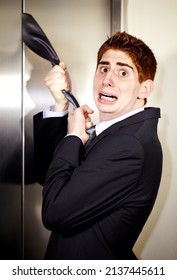 This Is Why I Hate Ties. A Young Businessman With His Tie Stuck In The Elevator.