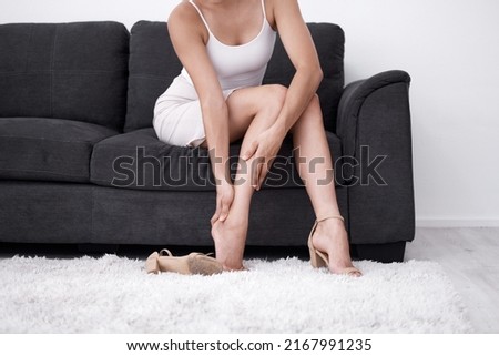 This is why I have a love-hate relationship with high heels. Shot of a woman rubbing her feet after wearing heels.