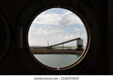 This Window In The Form Of A Circular Hole Looks Directly At An Electric Band Where Coal Is Transported From The Most Important Open Pit Mine In South America.