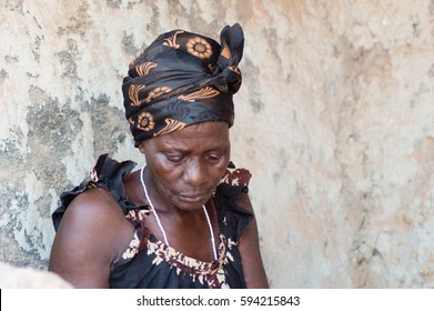 This Woman Is Dressed Like Most African Women Living In The Village. The Head Tied With A Scarf And With A Camisole Loincloth