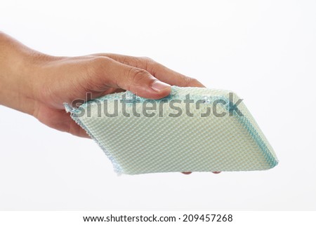 This woman's hand is cleaning with sponge on white background.