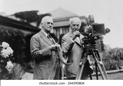Thomas Edison 1847-1931 and George Eastman 1854-1932 standing with motion picture camera ca. 1925.