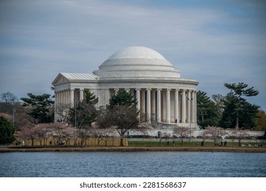 Thomas Jefferson Memorial surrounded by Japanese Cherry Blossom trees in full bloom as seen from across the Tidal Basin - Powered by Shutterstock