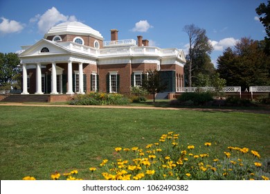 Thomas Jefferson's Monticello home with yellow flowers in foreground and bright blue sky in background in Charlottesville, Virginia