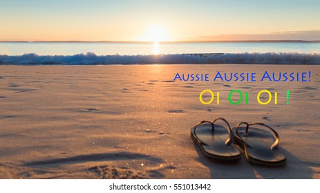 Thongs on beach with Aussie Oi word for Australia Day at sunrise sunset