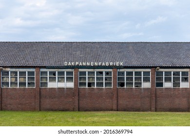 Thorn, The Netherlands, July 24th 2021. Old Rooftop Tile Factory With Broken Glass Windows In The Exterior Facade And Traditional Wavy Rooftop Tiles In Limburg