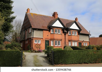 Thornton Hough, Merseyside, England, UK.  March 9, 2019. A pair of identical, symmetrical semi-detached red brick houses. - Shutterstock ID 1359438746