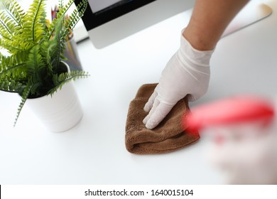 Thorough Cleaning Workplace, Near Home Computer. Human Hand In White Silicone Glove Wipes Surface Table With Towel. Apartment And Office Cleaning, Cleanliness Service. Maid Is Cleaning Hotel Room.