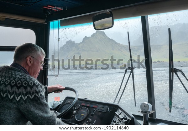 Thorsmork,Iceland-06.05.2019: Driver of an\
off-road bus pays close attention when crossing river in Thorsmork\
valley, Southern\
Iceland.