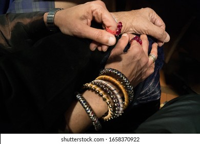 Thought Provoking Mood Image Of Women's Hands Wearing Antique Rings And Bangles.