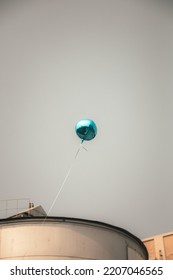 Thought Provoking Photo Of A  Blue Balloon In The Sky.