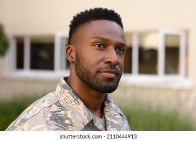 Thoughtful African American Army Soldier With Beard Looking Away Against House. Patriotism And Identity, Unaltered.