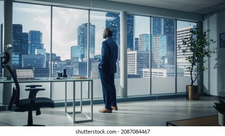 Thoughtful African-American Businessman in a Perfect Tailored Suit Standing in His Office Looking out of the Window on Big City. Successful CEO Planning His Investment Strategy for e-Commerce Startup - Shutterstock ID 2087084467