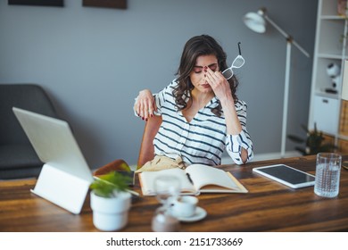Thoughtful anxious business woman looking away thinking solving problem at work, worried serious young woman concerned make difficult decision lost in thought reflecting sit with laptop