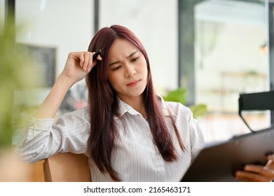 Thoughtful asian businesswoman or female office worker pensive thinking the solution plan, finding an inspiration idea for her work project assignment in the office. - Shutterstock ID 2165463171