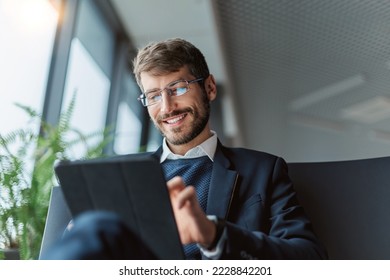 thoughtful business man with a digital tablet . - Powered by Shutterstock