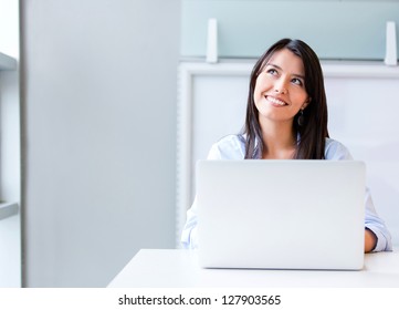 Thoughtful Business Woman Working On A Laptop