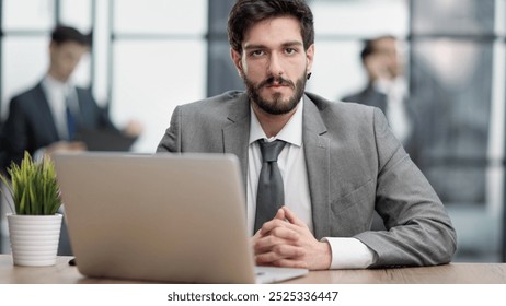 Thoughtful businessman pondering ideas or strategy, sitting at wooden with laptop, - Powered by Shutterstock