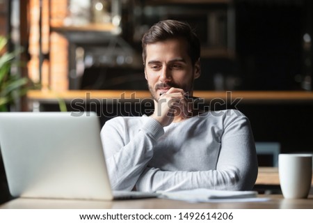 Thoughtful businessman think of online project looking at laptop at workplace, dreamy professional consider solution sit at work desk with computer, student search new idea inspiration in office cafe
