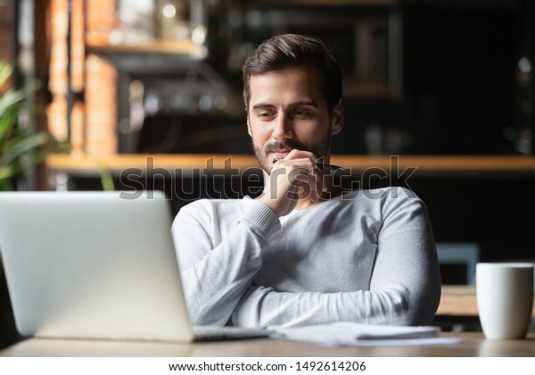 Thoughtful businessman think of online project looking at laptop at workplace, dreamy professional consider solution sit at work desk with computer, student search new idea inspiration in office cafe