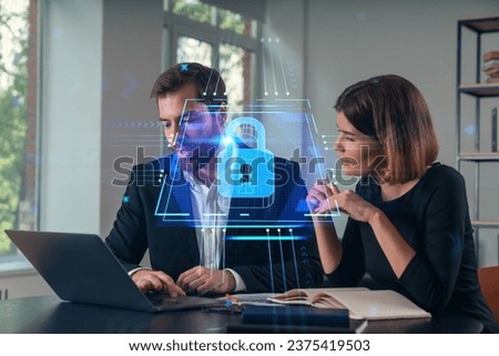 Thoughtful businesspeople typing on laptop at office workplace. Concept of team work, business education, internet surfing, brainstorm, project information technology. Lock data security hologram