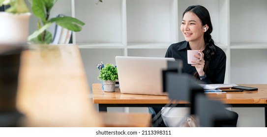 Thoughtful businesswoman with digital tablet looking through window while sitting on table. - Powered by Shutterstock