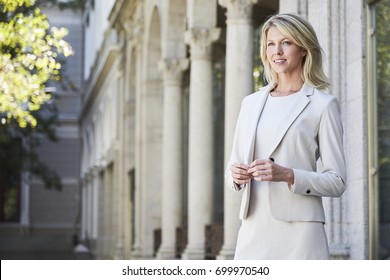 Thoughtful businesswoman in smart suit, looking away