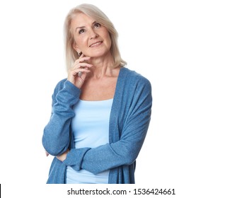Thoughtful casual senior woman looking up - isolated over a white background